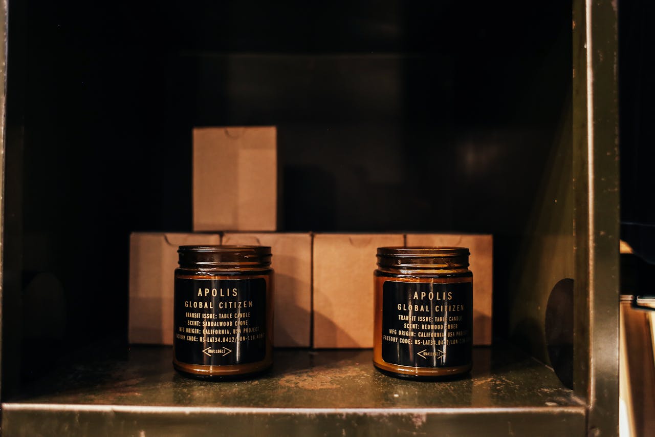 Stylish brown glass candles on display in a dark, minimalist room. Perfect for decor themes.